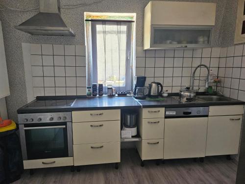 a kitchen with a sink and a stove top oven at Gästewohnung in der Nähe des Ferienparks Plötzky in Plötzky
