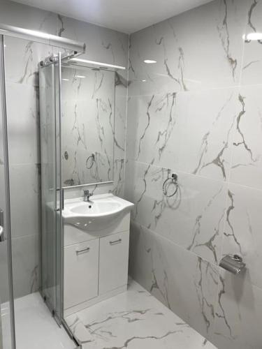 a bathroom with a sink and a shower at Floriana Cosy Corner in Il-Furjana