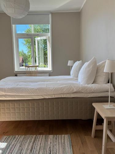 a bedroom with a large bed with a window at Bo i Bodafors in Bodafors