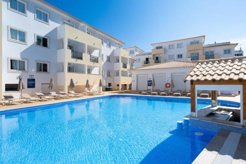 a large swimming pool in front of a building at Smy Santa Eulalia Algarve in Albufeira