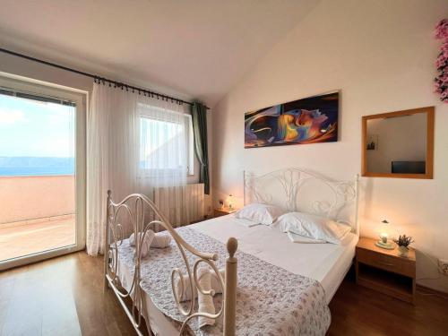 a bedroom with a white bed and a large window at APP St Marin view Novi Vinodolski in Novi Vinodolski