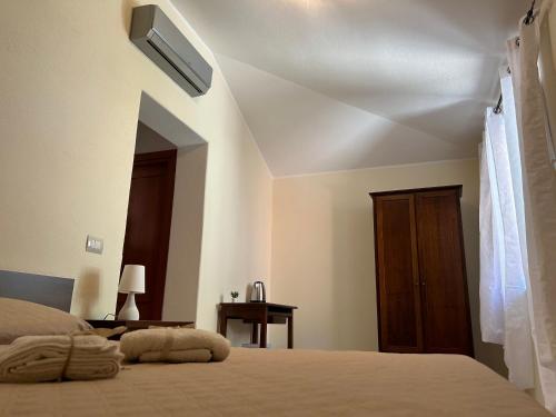 a bedroom with a bed and a wooden door at Palazzo 1815 in Papasidero