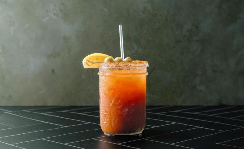 a drink with a lemon on top of a table at Holiday Inn Resort Grand Cayman by IHG in George Town