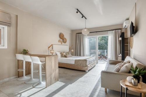 a bedroom with a bed and a living room at Stavroula Studios in Paleokastritsa