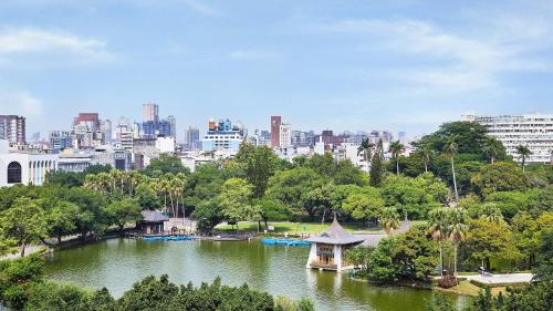 a lake in a park with a city in the background at Holiday Inn Express Taichung Park by IHG in Taichung