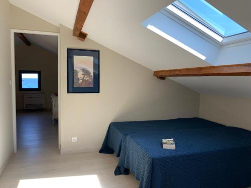 - une chambre mansardée avec un lit bleu dans l'établissement Pleine mer, à La Seyne-sur-Mer