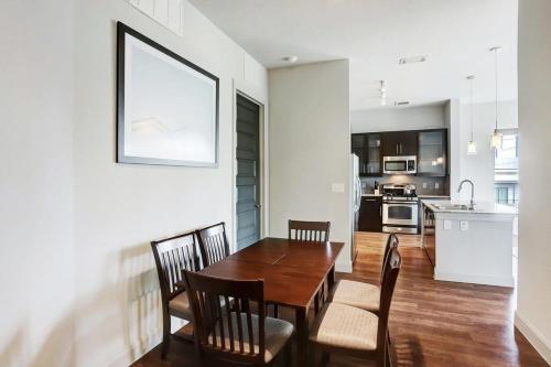 a kitchen and dining room with a wooden table and chairs at Jade At Millennium - 3 Bed Apt in Houston in Houston