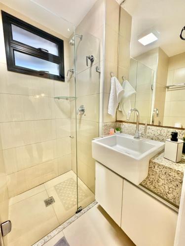 a bathroom with a glass shower and a sink at Landscape Beira-Mar Perfect in Fortaleza