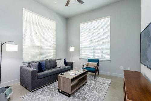 a living room with a couch and a chair at Peony At Millennium - Elegant 2 Bed Apt in Houston in Houston