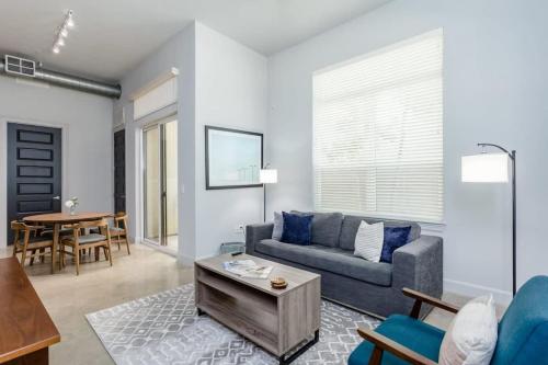 a living room with a couch and a table at Peony At Millennium - Elegant 2 Bed Apt in Houston in Houston