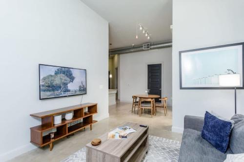 a living room with a couch and a table at Peony At Millennium - Elegant 2 Bed Apt in Houston in Houston