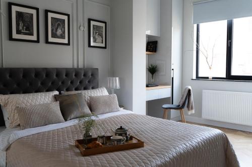 a bedroom with a large bed with a tray on it at Easy Rest in Tbilisi City