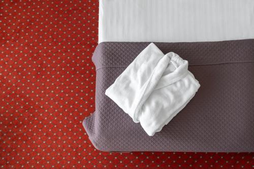 a piece of white napkin sitting on top of a bed at Europa Royale Druskininkai in Druskininkai