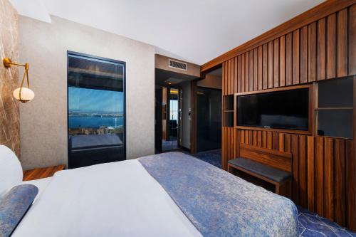 a hotel room with a bed and a television at Ring Stone Hotels Bosphorus - Special Class in Istanbul