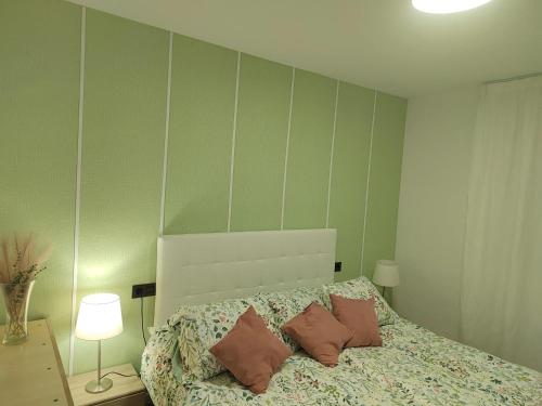 a bedroom with a bed with pillows on it at Bright apartment with sea view, Fuengirola, 50 m², pool in Fuengirola
