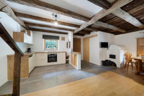 a kitchen with white walls and wooden ceilings at Unterurbanhof Apt Die Eins in Unsere Liebe Frau im Walde