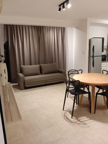 a living room with a table and a couch at Alójate 12 - Moderno y luminoso - 4 o 2 personas Zona Hospital Español-Estadio Unico in La Plata