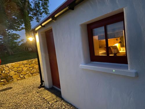 a window on the side of a building at Farm Stay at THE GLEBE COTTAGE KILREA in Tamlaght