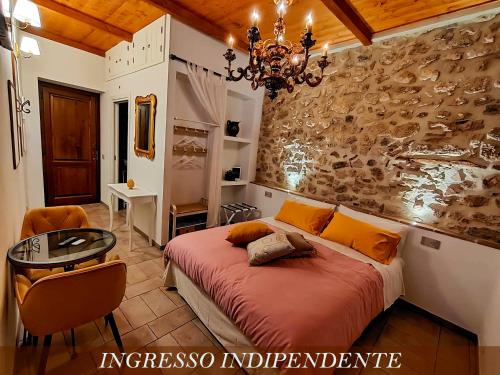a bedroom with a large bed and a chandelier at Dal Podestà in San Gemini