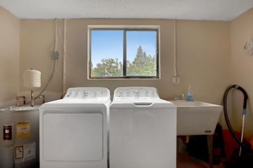 two white appliances in a room with a window at Spacious Townhome 5 Mins Walk to Beach in Cocoa Beach