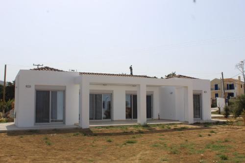 a white house with large windows at BEACH WHITE VILLAs in Minia