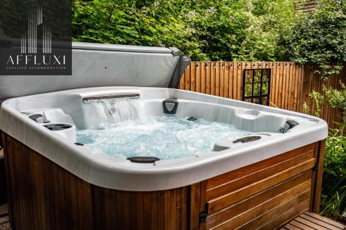 a hot tub with water in it in a backyard at Ironbridge Hot Tub Retreat - Sleeps 10 in Telford