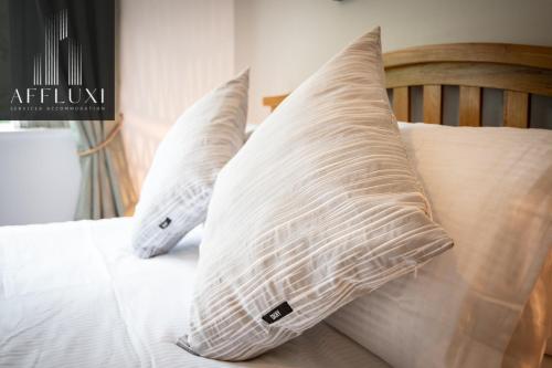 three pillows are sitting on a bed at Ironbridge Hot Tub Retreat - Sleeps 10 in Telford