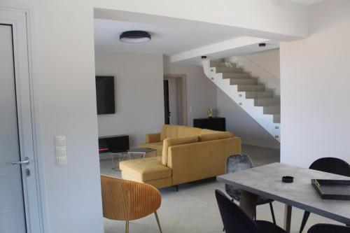 a living room with a couch and a table at BEACH WHITE VILLAs in Minia