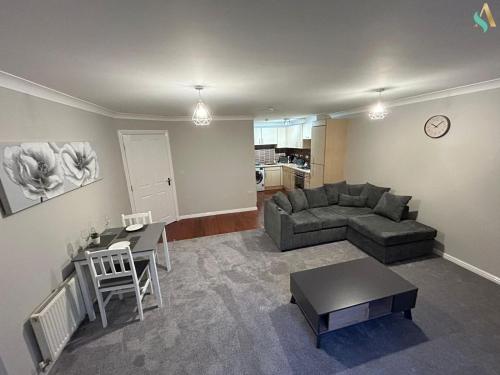 a living room with a couch and a table at Thornaby Lodge in Thornaby on Tees