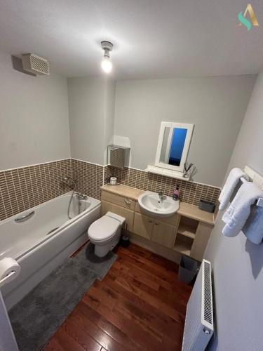 a bathroom with a toilet and a tub and a sink at Thornaby Lodge in Thornaby on Tees