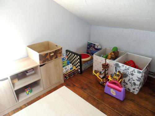 a room with toys and boxes on the floor at La Séliniére ! in Champ-du-Boult