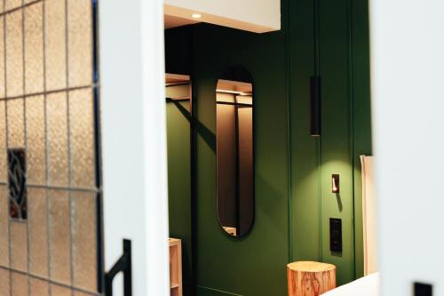 a hallway with green walls and a door at Mondragon Hotela in Arrasate - Mondragon