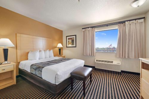 a hotel room with a bed and a large window at Best Western Plus Executive Inn & Suites in Manteca