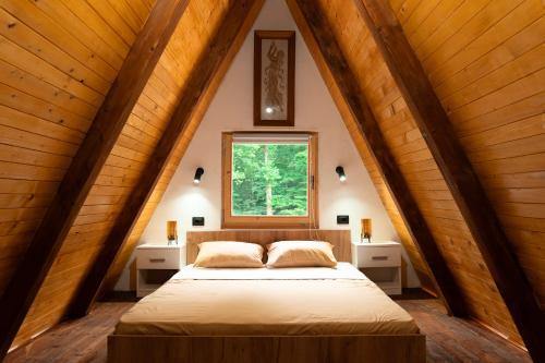 a bedroom with a bed in a attic at Jerry's Forest in Banja Luka