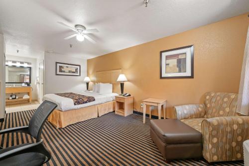 a hotel room with a bed and a couch at Best Western Plus Executive Inn & Suites in Manteca