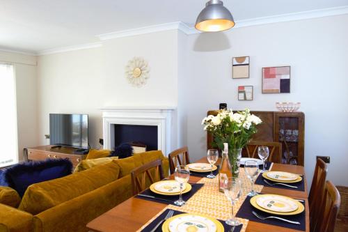 a living room with a table and a couch at Family Seaside Bungalow - Max 6 Adults Only in Margate