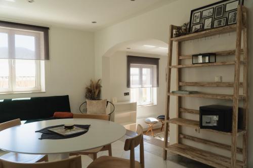 a living room with a table and a book shelf at City Center Hvar in Hvar