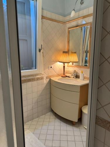 a bathroom with a sink and a mirror at Pesciolino Rosso in Cesenatico