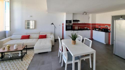un salon avec un canapé blanc et une table dans l'établissement Appartement T3 Duplex sous les Toits de Marseille Panier Vieux Port, à Marseille