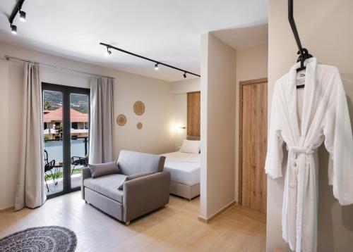 a hotel room with a bed and a chair at Baron Suites in Vasiliki