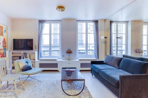 un salon avec un canapé et une table dans l'établissement GuestReady - Appt d'architecte dans le Marais, à Paris