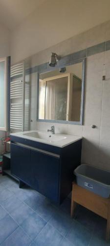 a bathroom with a sink and a mirror and a tub at Gullo Capo Vaticano in Ricadi