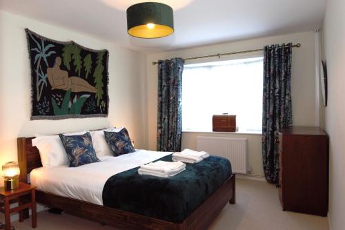 a bedroom with a bed with a large window at Family Seaside Bungalow - Max 6 Adults Only in Margate