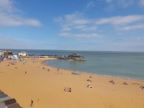 a group of people on a beach near the ocean at Family Seaside Bungalow - Max 6 Adults Only in Margate