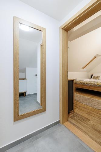a mirror in a room with a bedroom at APARTMÁNY Sninský dvor in Snina