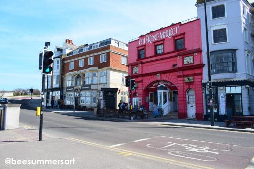 a red building on a city street with a traffic light at Family Seaside Bungalow - Max 6 Adults Only in Margate