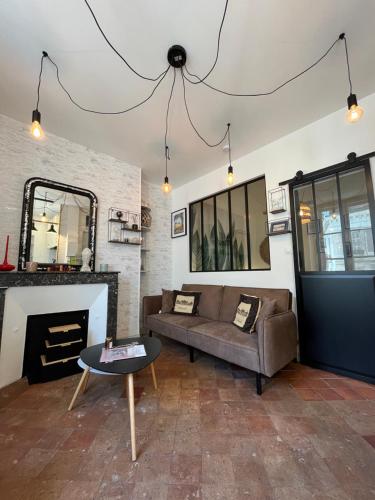 a living room with a couch and a fireplace at Côté Escaliers - Cosy appartement au cœur de Blois in Blois
