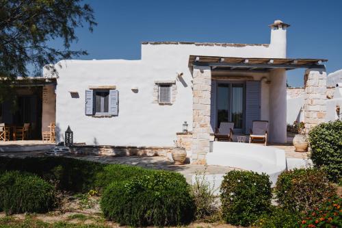 a white house with a porch and a yard at Kalma villa in Santa Maria