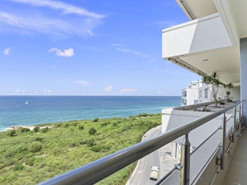 a balcony with a view of the ocean at Breathtaking Lagoon Views At Blue Residence in Cupecoy