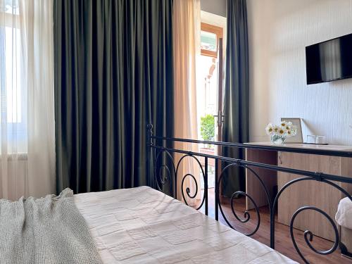 a hotel room with a bed and a window at Betlemi Old Town Hotel in Tbilisi City